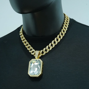 Close-up of gold cuban link necklace with hip hop iced out rectangular pendant detail