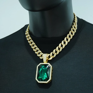 Detail of hip hop Cuban link necklace with large emerald-cut green stone and sparkling crystals