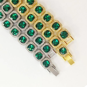 Close-up of hip-hop bracelets featuring square green emeralds with rhinestone accents
