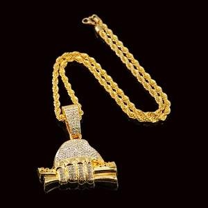 Détail macro de la chaîne torsadée hip hop et pendentif main tenant des billets