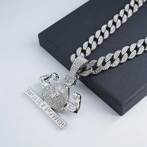 Macro shot of money power pendant with iced-out dollar bag and muscular arms details