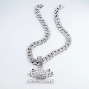 Detailed close-up of Money Power money bag pendant with iced out Cuban chain