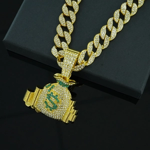Gold Cuban chain necklace featuring a dollar money bag pendant with green and clear zircons