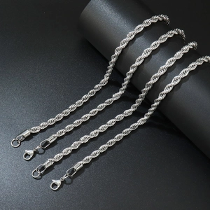Detail of four silver stainless steel rope chains with lobster clasp on black background