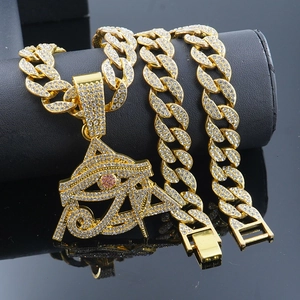 Iced-out gold hip hop necklace featuring Eye of Horus pendant and Cuban chain links