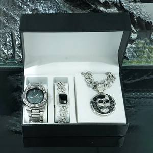 Detail view of iced-out hip hop skull pendant necklace and crystal watch set in gift box