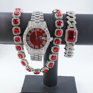 Detailed view of silver luxury watch with red dial and matching ruby stone jewelry set
