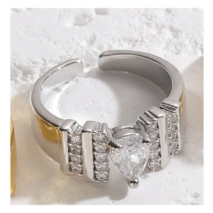 Macro shot of silver adjustable ring featuring a pear-cut zircon and step-set side stones