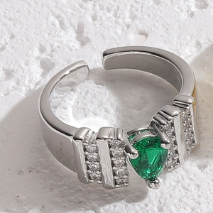 Macro shot of silver adjustable ring featuring a pear-cut green zircon and micro pavé