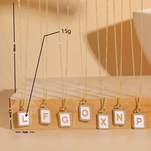 Rectangular zircon initial pendant necklace with gold letters and white enamel coating