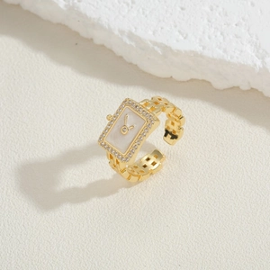 Detailed macro of the pave-set cubic zirconia rectangular face on gold watch-style ring