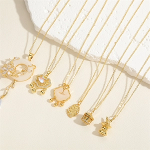 Detail of vintage gold necklaces with shell inlay, zircon accents and Ruyi pendants