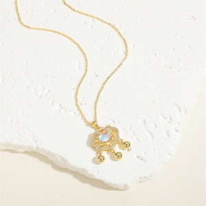 Detail of vintage gold-plated necklace with white zircon and shell padlock pendant