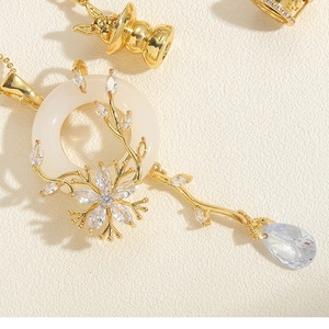 Close-up of golden vintage necklace pendant with white shell ring and zircon inlay