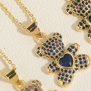Macro shot of bear pendants with colorful crystals and heart-shaped blue stones