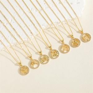 Macro shot of 14K gold-plated zodiac pendants with sparkling white zircons on O-chains