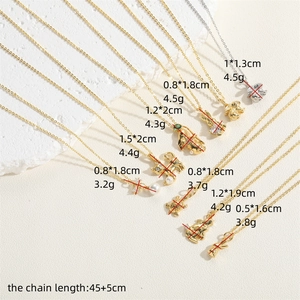 Golden and silver animal zircon pendant necklaces with pearls on textured stone background