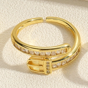 Macro shot of gold belt buckle ring featuring rectangular clear zircon inlay
