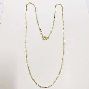 Detailed view of a gold water wave necklace with a secure lobster clasp on white background
