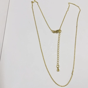 Close-up of gold plated O-chain necklace featuring a lobster clasp and teardrop extension