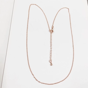 Detail of rose gold O-link chain with lobster clasp and teardrop extender charm