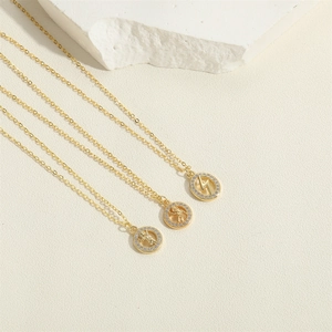 Golden pendant necklaces with astronaut and lightning designs featuring pavé cubic zirconia