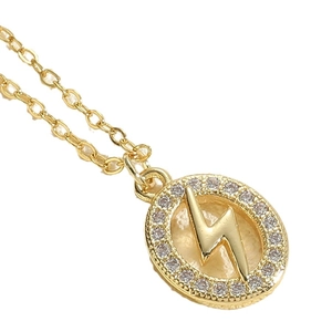 Elegant gold oval pendant necklace featuring a lightning bolt symbol and zircon stones