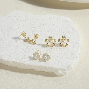 Elegant rose tulip and pearl stud earring set with gold finish on marble stone base