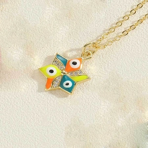 Macro detail of star pendant necklace with colorful evil eye enamel and zircon stones