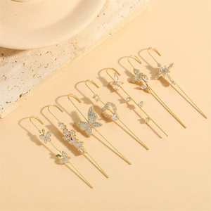 Elegant gold ear crawlers with butterfly and cross designs featuring zircon accents