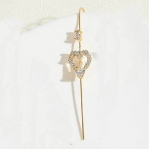 Close-up of golden heart-shaped ear hook with pave-set zircon crystals and long bar