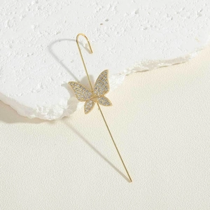 Detailed view of a gold butterfly ear cuff featuring micro-pave white zircons on rock