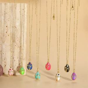 14K gold plated oval enamel egg necklaces with intricate hollowed floral patterns