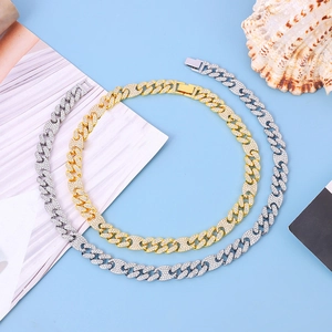Close-up of iced out Cuban link necklace set in gold and silver with zircon inlays