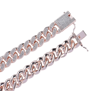Macro detail of rose gold Cuban link chain with paved crystals and secure square buckle