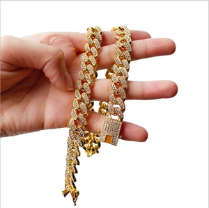 Détail d'une chaîne à maillons cubains hip hop sertie de strass blancs et fermoir double