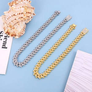 Macro detail of iced-out wavy Cuban chain links with pave crystals in gold and silver