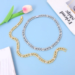 Detail of pavé-set Cuban link necklace and bracelet in gold and silver finish