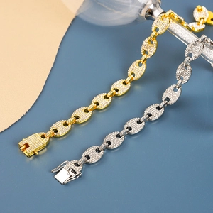 Macro detail of iced-out coffee bean link bracelets in gold and silver finish