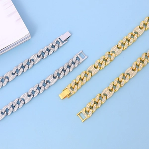 Close-up of Cuban link bracelets with sparkling zircon stones in gold and silver finish