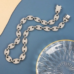 Macro detail of silver mariner link necklace with full pave white zircon setting