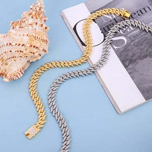 Macro shot of gold and silver hip hop Cuban link necklaces with iced-out pave zircons