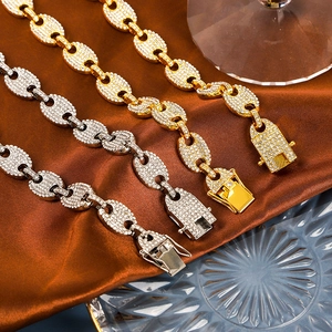 Macro detail of iced-out coffee bean link chain with sparkling white zircon crystals