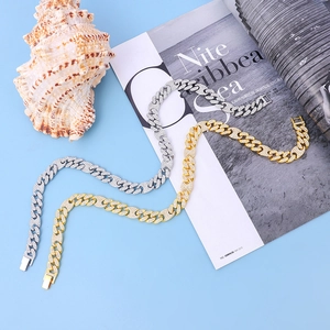 Detailed macro view of gold and silver iced out Cuban link chains with crystal zircon setting