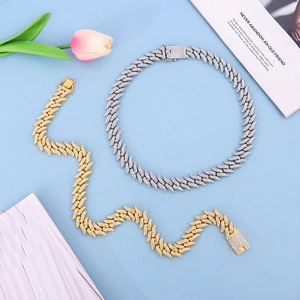 Detail view of iced-out Cuban link chains in gold and silver finish with micro pave stones