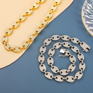 Detail of gold and silver hip hop coffee bean link chains with sparkling crystal pave