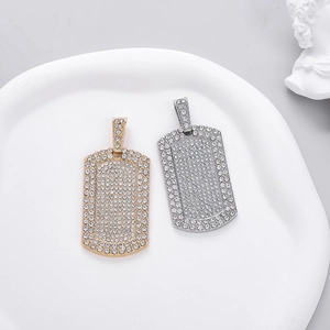 Hip hop dog tag pendants in gold and silver with shimmering full rhinestones set on white tray