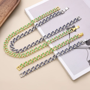 Close-up of iced out Cuban link bracelets with gold and silver enamel finish details