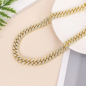 Close-up of 15mm gold-plated cuban link chain with shimmering white rhinestones