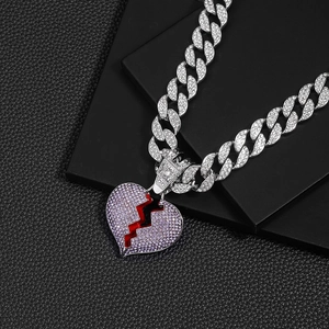 Close-up of hip-hop Cuban chain with iced-out broken heart pendant and purple zircon